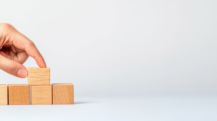 Poster - Closeup of Hand Placing Wooden Block in Business Concept