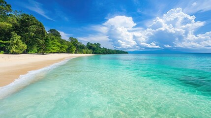 Wide view of a holiday beach with turquoise water, leaving plenty of space for copy.