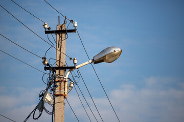 A street light is lit up in the daytime