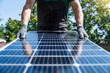 © Westend61 - Engineer wearing gloves and holding solar panel