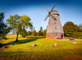 Authentic old wooden Lithuanian windmill on the countryside. Splendid summer vew of popular tourist attraction - Staciunu vejo malunas, Staciunai village, Pakruojis District Municipality, Lithuania.