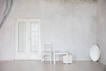 Poster - table, chair and mirror in the interior of an empty white room