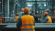 © nikomsolftwaer - Workers in safety vests and helmets operating machinery at a construction site with safety signs