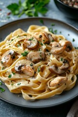 Creamy chicken fettuccine with mushrooms served on a rustic wooden table