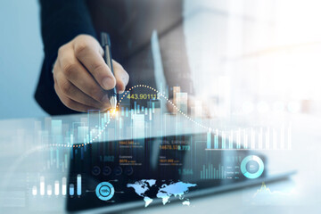 Leinwandbilder - Businessman using tablet with digital visualization of analyzing data sales and financial graph chart. Business development strategy,analysis and planning.