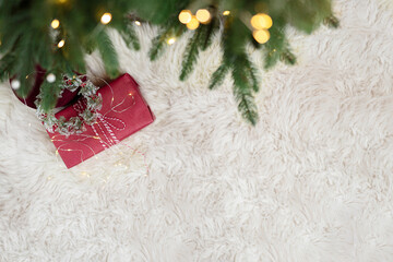 Christmas and New Year concept. Top view of red Christmas gift box, Christmas snowflake, it is white fluffy in the background
