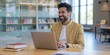 © Reubens Stock Photos - Young Professional Man Wearing Traditional Indian Wear Using Laptop at Home Library Setting