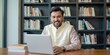 © Reubens Stock Photos - Professional Man Wearing Traditional Indian Wear Using Laptop at Home Library Setting