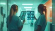 © Jhon - Two female doctors reviewing X-ray images