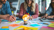 © Mirjana - Collaborative brainstorming workshop in a creative space featuring charts, notes, and a light bulb idea symbol on the table