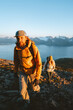 © EVERST - Mountain guide man and woman hiking in Norway together healthy lifestyle outdoor active people family vacations adventure tour, friends climbing together, freedom concept