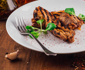 Wall Mural - Grilled chicken breast on white plate being served on wooden table