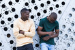 © BUDDHA - Two young african friends talking on the street