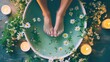 © Suphawan - A relaxed woman soaking her feet in a warm herbal bath, surrounded by fresh flowers, candles, and spa essentials, creating a tranquil spa experience.