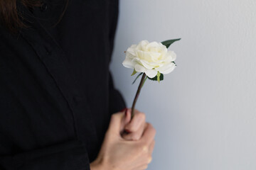 person holding a flower in grief