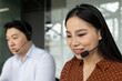 © Liubomir - Customer service agents engaging with clients using headsets in office environment. Teamwork and communication emphasized through focused expressions and professional attire, ensuring support.