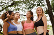 © gumpapa - Happy smiling female friends. Woman talking and having fun in park after finish fitness yoga class exercise on weekend morning.
