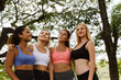 © gumpapa - Happy smiling female friends. Woman talking and having fun in park after finish fitness yoga class exercise on weekend morning.