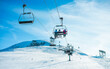 © DisobeyArt - People on ski lift in winter sport resort - Travel and vacation concept - Focus on three people body
