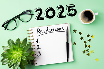 Wall Mural - New year resolutions 2025 on desk. 2025 goals list with notebook, coffee cup, plant on desk. Resolutions, plan, goals, action, checklist, idea concept. New Year 2025 resolutions, copy space