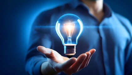 Business entrepreneur hold energetic blue light bulb in hand. Symbol of innovation growth idea creativity technology power