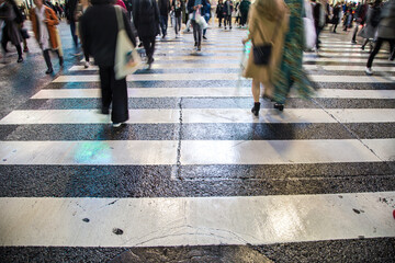 Blurred buisness background of people walking cross Shibuya Crossing intersection road