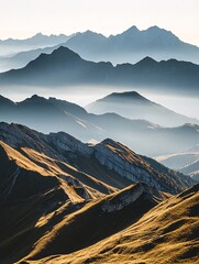 Wall Mural - Misty mountain range with a golden glow at sunrise.