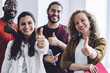 © BullRun - Successful young students showing thumbs up