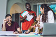© BullRun - Communicating young students in modern office