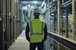 © Salander Studio - an engineer in reflective vest and a hard hat inspecting a water treatment facility