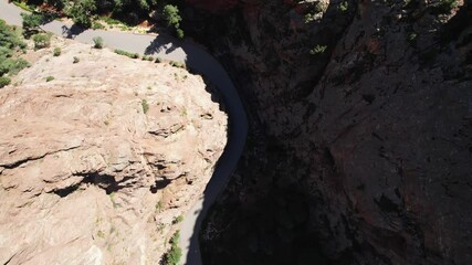 Wall Mural - A road through high rocky mountains, top dawn view.