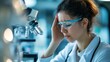 © Fay - Tired and frustrated scientist in lab with a headache. Woman wearing lab coat and safety glasses working in science laboratory.