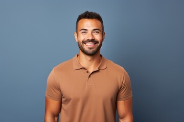 Wall Mural - Portrait of a satisfied man in his 30s wearing a sporty polo shirt in blank studio backdrop