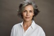 © Markus Schröder - Portrait of a tender woman in her 50s wearing a classic white shirt isolated in blank studio backdrop