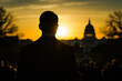 © Dzmitry - A speaker silhouetted against a stunning sunset over the Capitol while engaging an enthusiastic audience during an evening event