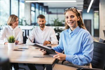 Wall Mural - Business woman with her staff, people group in background at modern bright office indoors.