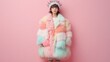 © familymedia - A woman stands confidently against a pink background, wearing a fluffy coat with pastel patches and a striking spiky crown, creating a bold fashion statement.