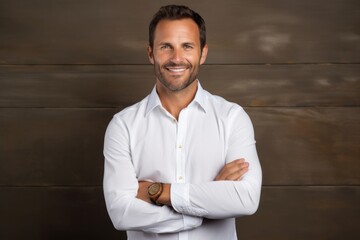 Portrait of a glad man in his 40s wearing a classic white shirt isolated on light wood minimalistic setup