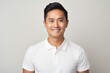 © Markus Schröder - Portrait of a grinning asian man in his 30s donning a classy polo shirt in front of plain white digital canvas