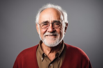 Wall Mural - Portrait of a smiling man in his 70s wearing a comfy flannel shirt in plain white digital canvas