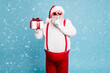 © deagreez - Hush its secret Portrait of focused funny funky fat santa claus with big abdomen belly prepare gift for eve noel hold small giftbox wear red pants suspenders isolated over blue color background