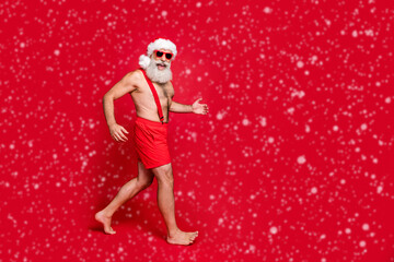 Poster - Full length body size view of his he nice attractive cheerful positive glad fit gray-haired man having fun holly jolly running travel isolated over bright vivid shine red background