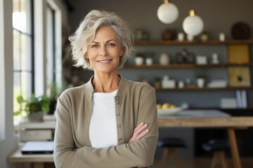 Sticker - Portrait of a glad woman in her 50s wearing a chic cardigan isolated in stylized simple home office background