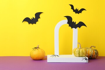 Canvas Print - Presentation of product. Podium and Halloween decor on purple table against yellow background. Space for text