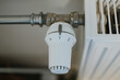 © Alina  - white modern heating knob on low battery mode for heating in apartments and houses. Heating prices.