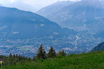 Aerial view of Italian City of Meran with Etsch Valley and Etsch River seen from mountain resort Meran 2000 on a sunny summer day. Photo taken July 18th, 2024, Meran Merano, Italy.