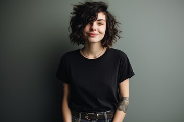 Sticker - Portrait of a blissful woman in her 20s sporting a vintage band t-shirt isolated in plain cyclorama studio wall