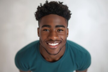 Poster - Close up portrait of a smiling young man with curly hair.