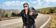 © Ljupco Smokovski - Biker in a black leather jacket carrying a tire and hitchhiking