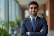 © Visual Odyssey - Happy indian business man in suit in modern office, Generative AI